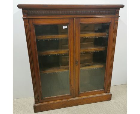 A carved mahogany glass fronted, four shelf bookcase, 107 x 92 x 31cm.