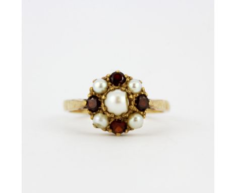 A hallmarked 9ct yellow gold ring pearl and garnet set ring, (N).