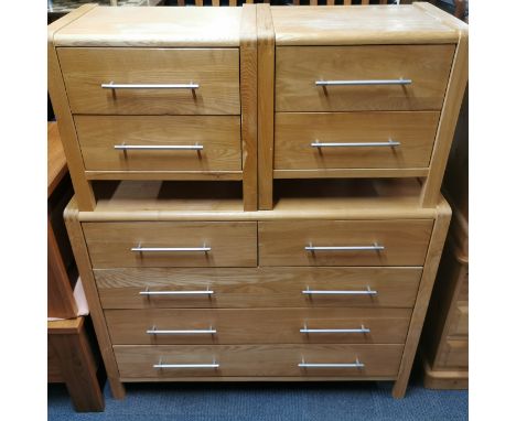 A modern light oak effect chest of drawers with metal handles, 110 x 86 x 46cm together with a pair of matching two drawer be