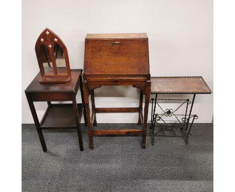 A small oak single drawer bureau, together with an oak and iron magazine rack, a further two tier table and a small mirror ba