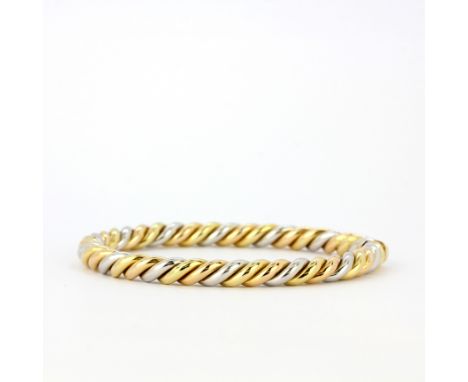 A heavy 18ct yellow and white gold twist design bangle, internal L. 6cm, approx. 31.7gr.&nbsp;