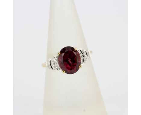 A 14ct yellow gold Art Deco style ring set with an oval cut garnet and diamond shoulders, (O).