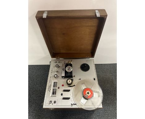 A vintage Akai reel to reel tape recorder.