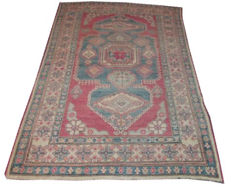 VINTAGE KAZAK CARPET, 320cm x 213cm, stylised hooked medallions on an abrashed sky blue field inside multiple organic motif b