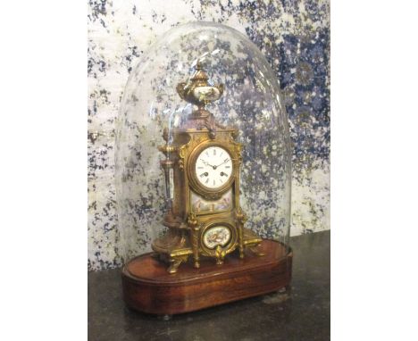 MANTEL CLOCK, late 19th century gilt metal and porcelain with French bell striking movement under a glass dome with rosewood 