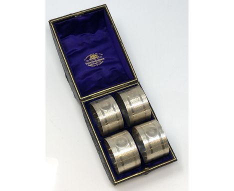 A good set of four silver napkin rings with engine turned decoration, numbered 1 2 3 4, Birmingham marks, in fitted Goldsmith