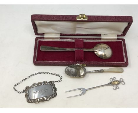 A boxed Arts &amp; Crafts silver spoon, decanter label, citrine-mounted fork and a silver scoop with mother of pearl handle