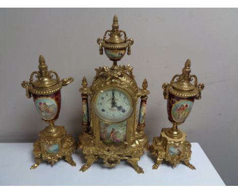 A three piece continental brass and ceramic clock garniture. 
