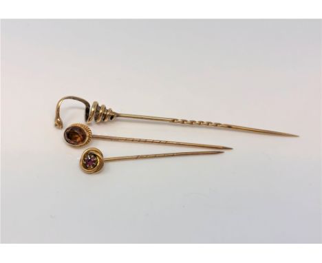 Three antique gold pins, one modelled as a snake, the others set with ruby and citrine (3)
