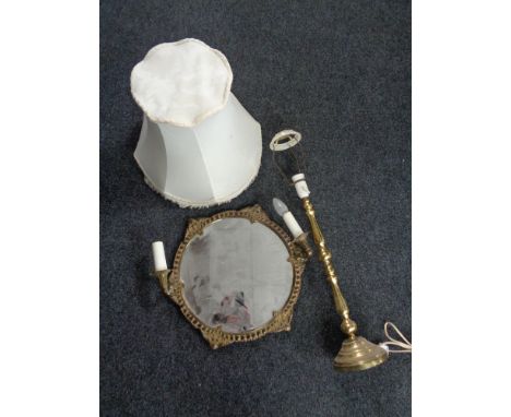 A Continental brass circular framed mirror with twin sconces together with a brass table lamp (continental wired)