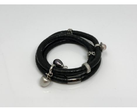 A Story Bangle by Kranz &amp; Ziegler with six silver charms including a black pearl