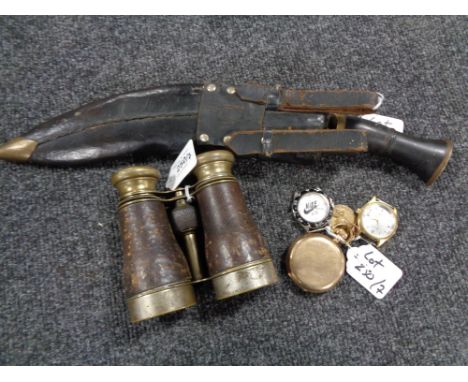 A pair of brass and leather-covered field glasses, a kukri knife in sheath, a ring, two wristwatches without straps, a medall