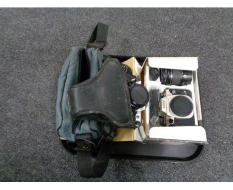 A tray of boxed Canon Eos 50E camera with lens together with a camera bag containing Canon EA-1 camera with lens 