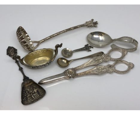 A group of silver and other items including caddy spoon, strainer, salt, grape scissors etc