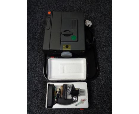 An MC Reflecta projector together with a cased microscope 