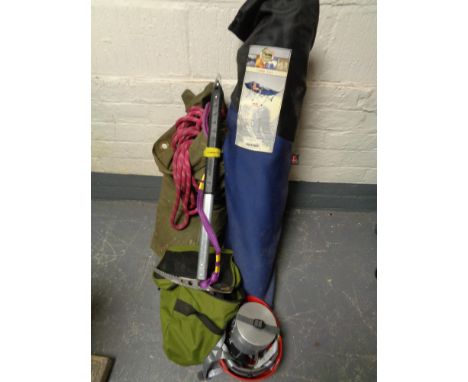 A box of rock climbing equipment, boots, helmet, ropes, axe, folding camp cot in carry bag 