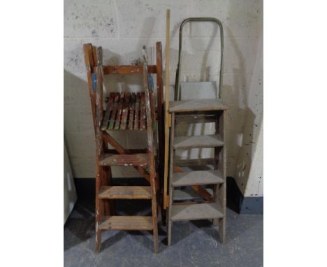 Three sets of wooden folding steps together with a metal folding step 