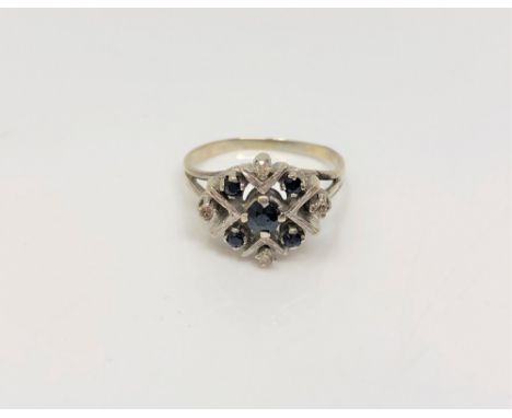 A white gold sapphire and diamond cluster ring, size O