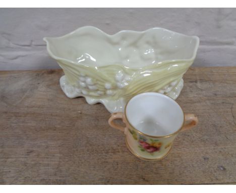 A hand painted Royal Worcester blush ivory twin-handled cup, height 3.8 cm, together with a Beleek shell dish. 