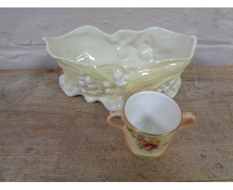 A hand painted Royal Worcester blush ivory twin-handled cup, height 3.8 cm, together with a Beleek shell dish. 