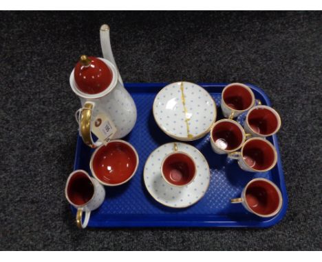 A Susie Cooper fifteen-piece bone china coffee service, decorated with blue snowflake decoration, gilt-rimmed and terracotta 