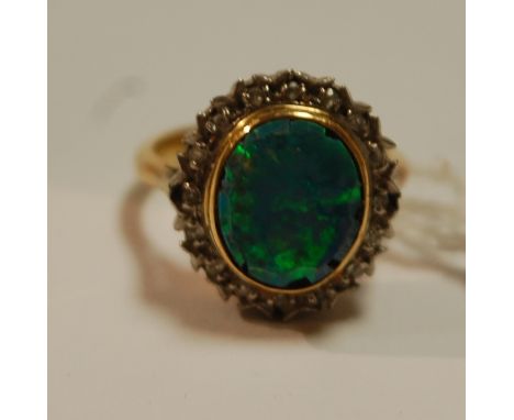 An 8ct gold and platinum opal set dress ring, size I