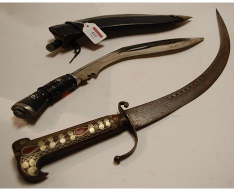 A 20th century tourist kukri in a leather scabbard together with a Moroccan dagger (2)