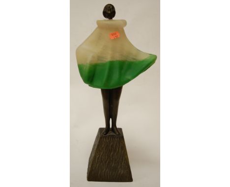 An Art Deco styled figural table lamp in the form of a girl, the frosted glass shade in the form of her dress