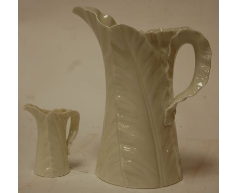 An early 20th century Royal Worcester blanc-de-chine leaf moulded jug, green mark verso; together with one other smaller exam