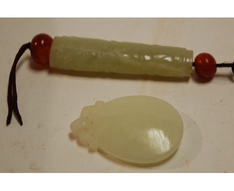 A Chinese carved jade tubular pendant; together with one other (2)