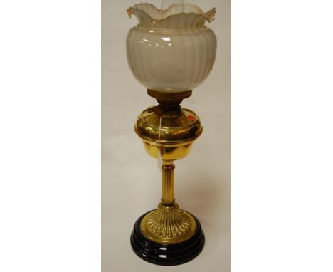 An early 20th century brass pedestal oil lamp having opalescent glass shade
