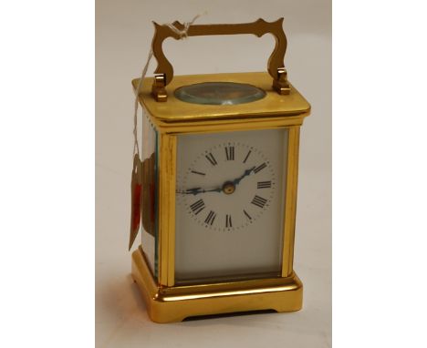 A modern lacquered brass cased carriage clock, having enamelled dial with Roman numerals and visible platform lever escapemen