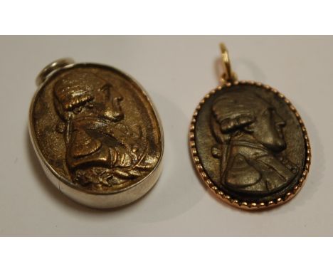 A reproduction silver pendant medallion depicting profile portrait of Napoleon together with one other gold backed example (2