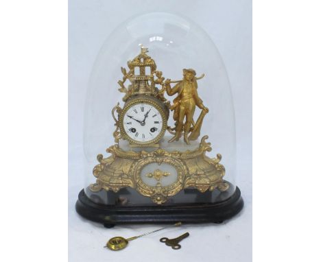A late 19th century gilt-spelter mantel clock with eight-day movement striking a bell, the case cast with a house and a figur