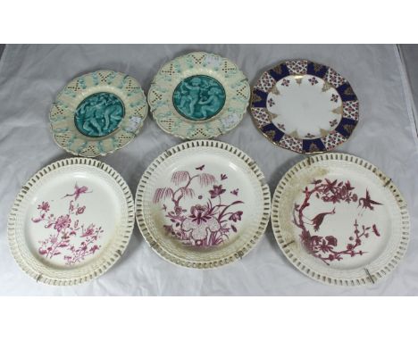 Six assorted ceramic plates including a pair of German pottery plates with scenes of putti moulded in relief and pierced oute