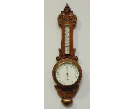 An early 20th century aneroid barometer by Dolland, London, No.6279, in carved oak case, 87cm 