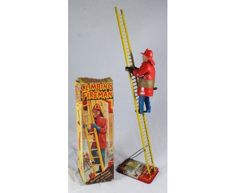 A mid-20th Century 'Climbing Fireman' by Marx of Great Britain, with plastic clockwork fireman, metal ladder and in original 
