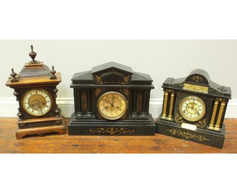 A Victorian black slate clock of classical temple form together with a similar ebonised wooden example and a stained-wood man