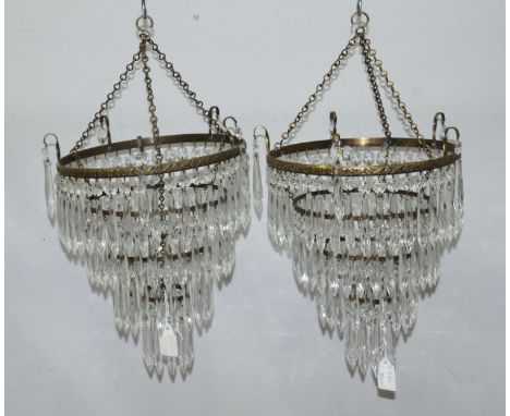 A pair of brass and cut glass four-tier lamp shades, approx. 25cm wide and 30cm from rim to base 