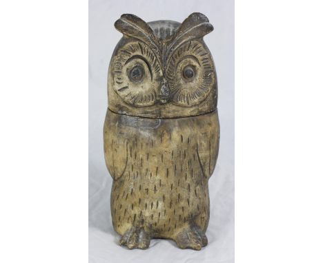A salt-glazed ceramic jar modelled as a seated owl, the removable head enclosing storage space. 27cm high 