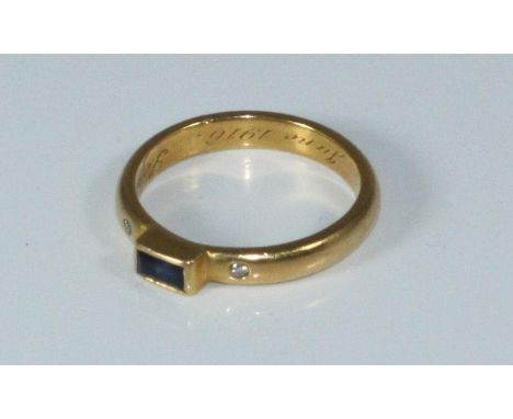 A 22ct gold diamond and sapphire ring, centrally set with a baguette sapphire, flanked by two small diamonds. Gross weight ap