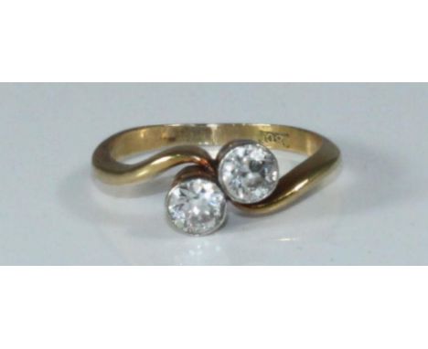 A 18ct diamond ring, of crossover design, set with two round   Old Cut diamonds, estimated total diamond weight 0.50 carats  