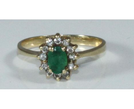 A 14K gold, emerald and diamond cluster ring, 2.77grams 