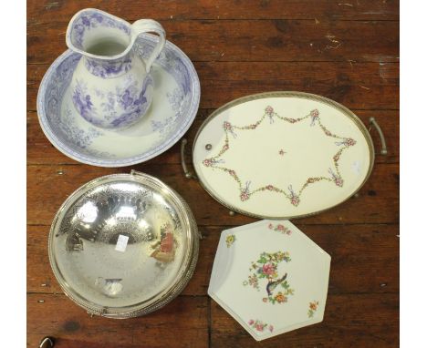 A silver-plated circular bread basket with swing handle, together with a circular salver, oval galleried tray, hexagonal porc