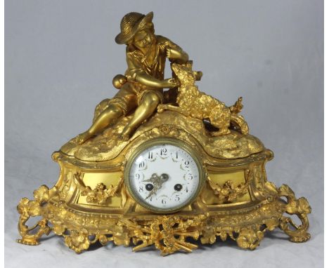 A late 19th century French gilt-spelter mantel clock with eight-day movement striking a bell, the case modelled with trophies