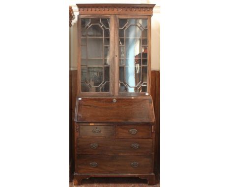 A George III stained mahogany bookcase with astragal glazed doors enclosing adjustable shelves, sloped front enclosing pigeon
