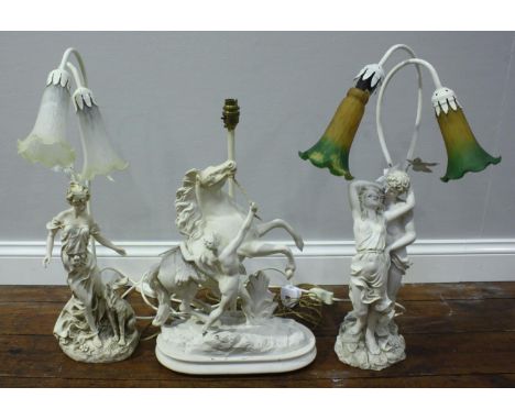Two white composition figural table lamps with glass bell-flower shades, 62cm high, together with a white-painted spelter Mar
