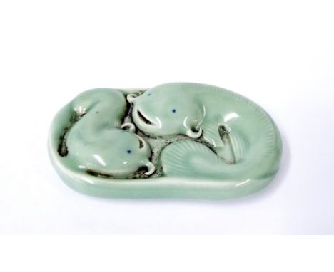 Small Chinese porcelain paperweight in the form of two coiled fish, calligraphy seal mark to base, 3.5" long