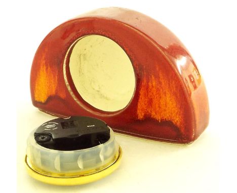 Poole Pottery mantel clock, the 2.5'' dial inscribed Poole fitted into a Volcano type pattern arched pottery case, 6'' long x