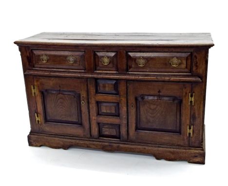 18th century elm dresser base, with three drawers and two opposing panel cupboard doors, 56" long, 34.5" high